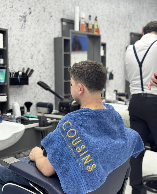 Fresh haircut at Cousins Brentwood Barbers with branded towel